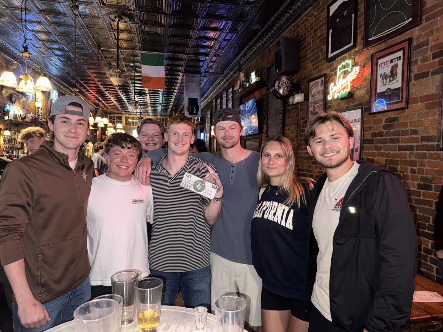 A winning team celebrating under the Irish flag at Finnegan's Wake